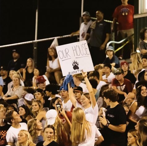 Aftin Allen,  Junior,  holds sign in the student section on Friday night 