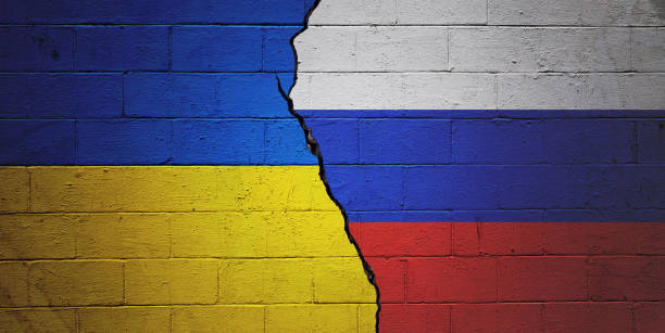 Cracked+brick+wall+painted+with+a+Ukrainian+flag+on+the+left+and+a+Russian+flag+on+the+right.