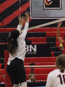 Volleyball girls at Mountain Ridge reach for the volleyball