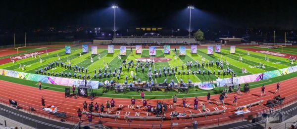 Marching band performs on football field