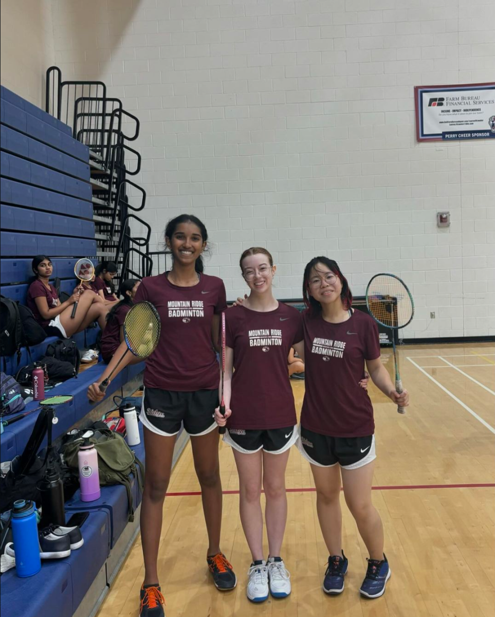 badminton players pose in gym