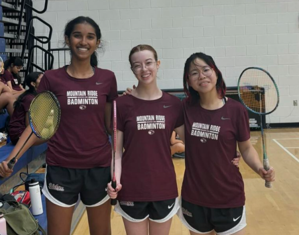 badminton players pose in gym