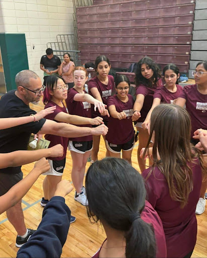 Badminton team huddles during game