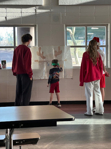 student government members help kid at drawing station