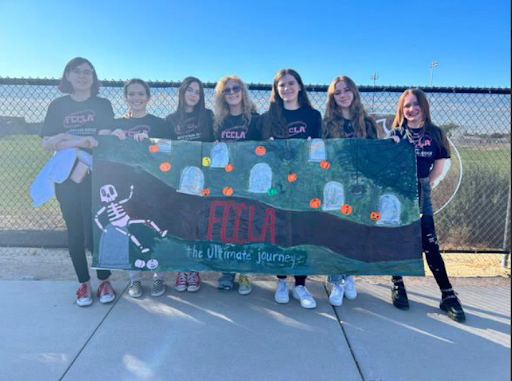 club members pose with a banner