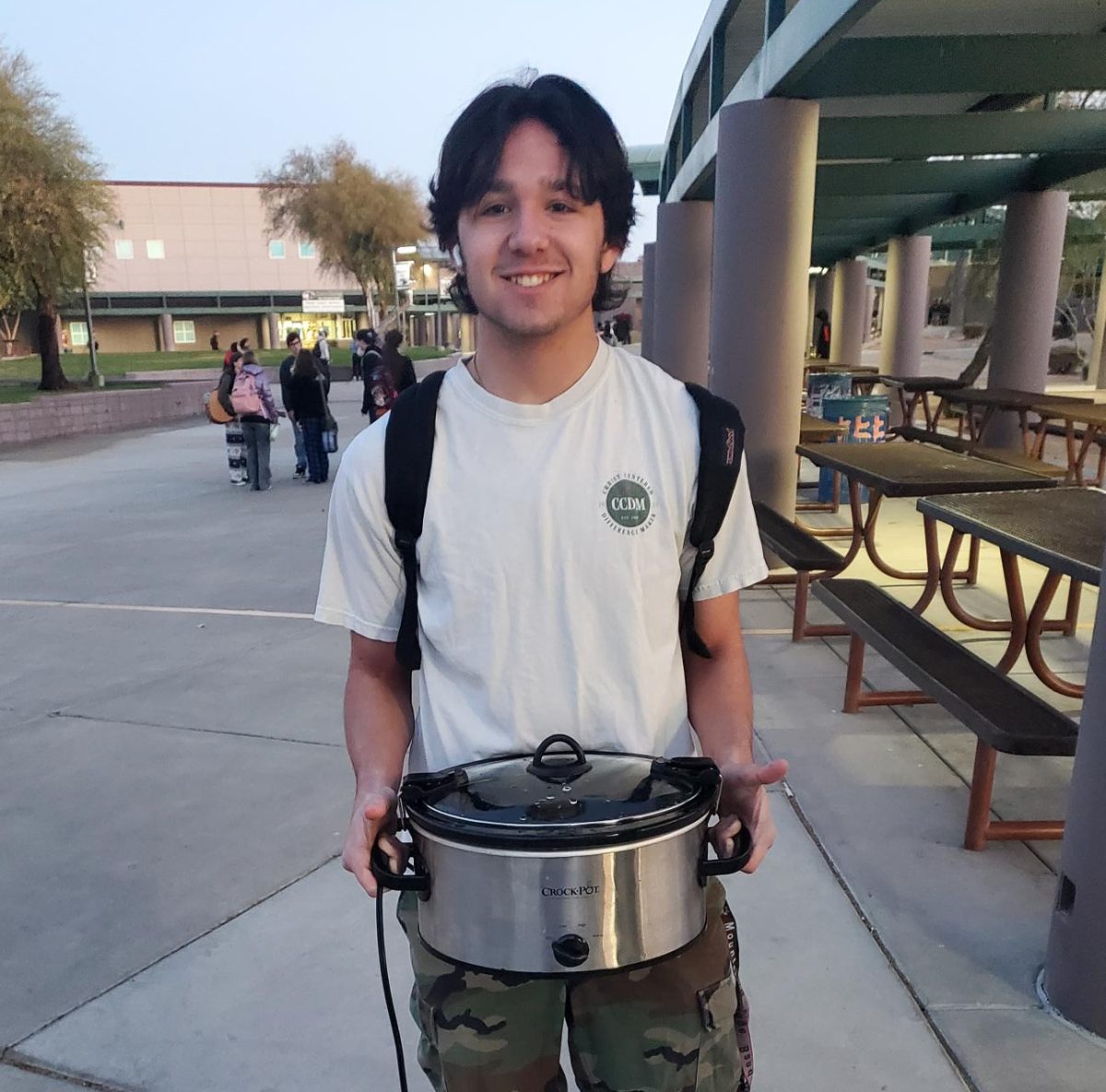 student holds a crockpot