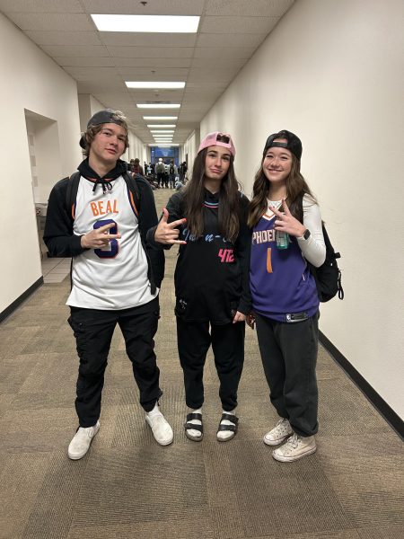 Three students pose in spirit gear