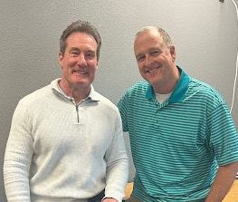 two teachers pose next to each other in classroom