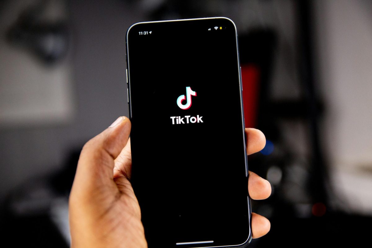 person holds phone open to TikTok app