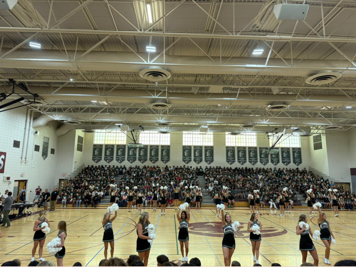 cheerleaders perform at assembly