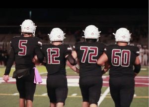 football captains walk across field