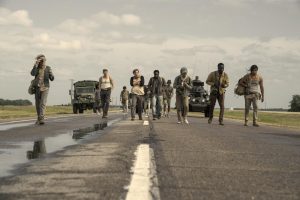 characters run down a road
