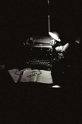 typewriter under lamplight